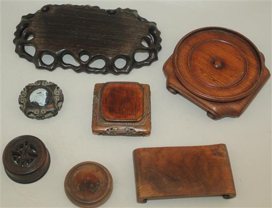 Six Oriental carved wood stands and a cover.